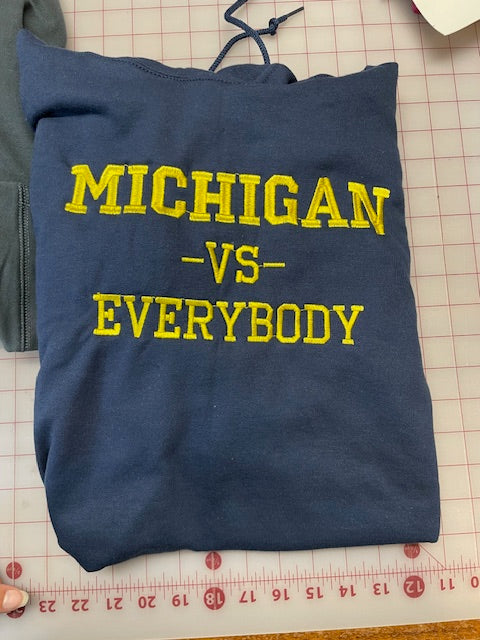 Michigan vs Everybody 1000th Win Gear Hoodies and Hats